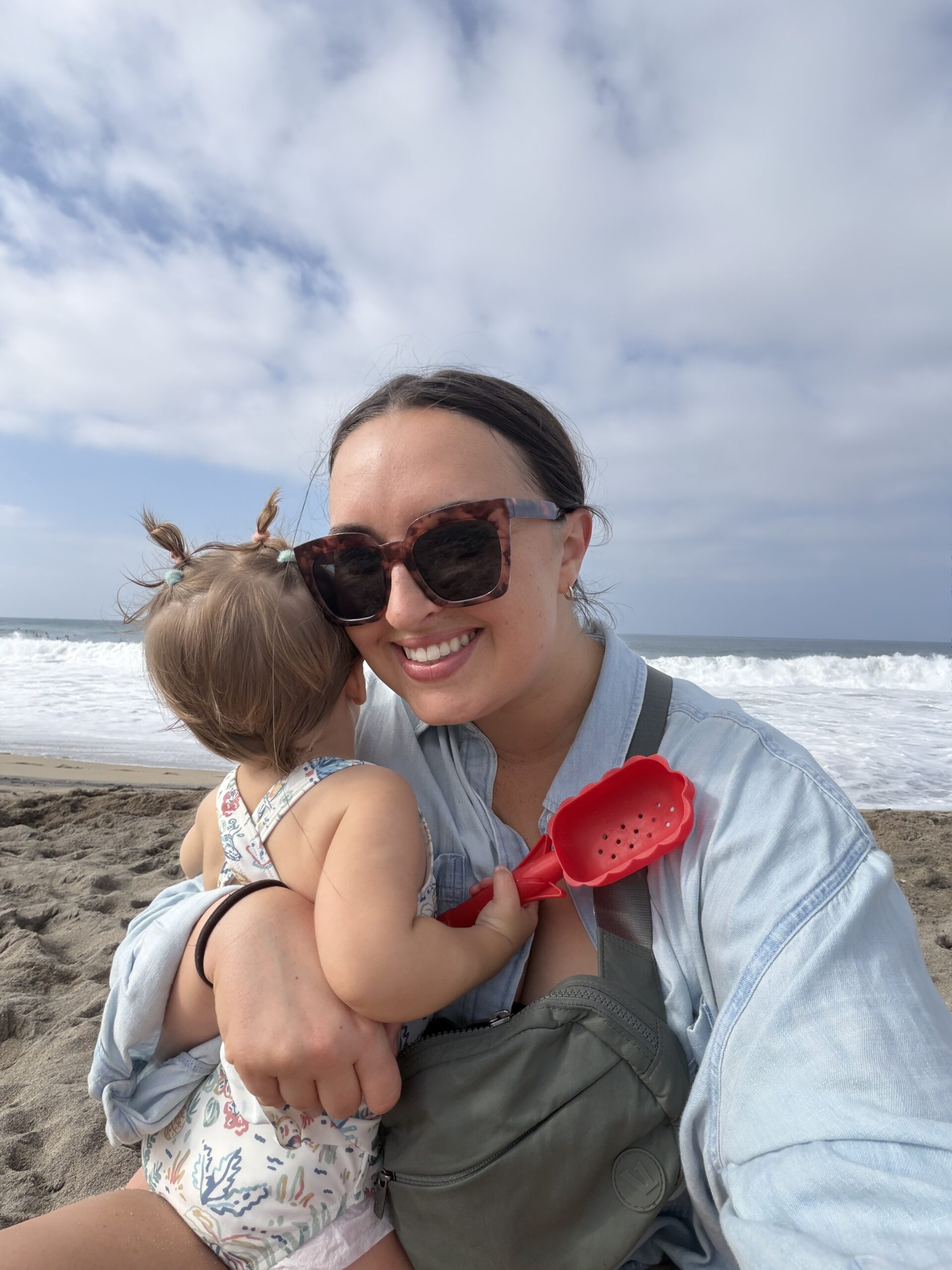 Hamilton, founder of Virtual Cornerstone, smiling while holding her baby